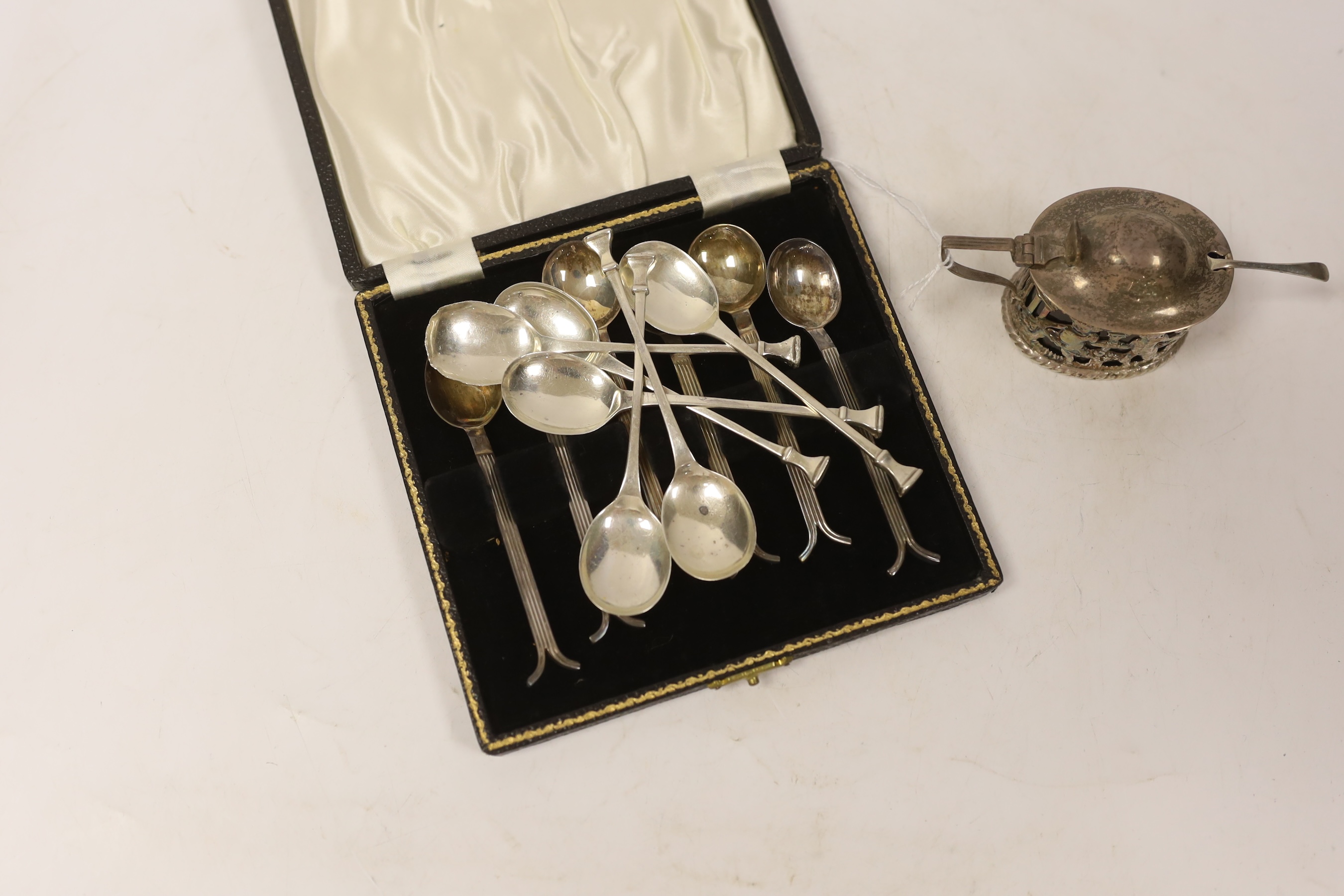 A cased set of six silver George VI silver teaspoons, with reeded stems and split terminals, Sheffield, 1946, one other set of six silver teaspoons (one spoon a.f.) and a pierced silver mustard pot.